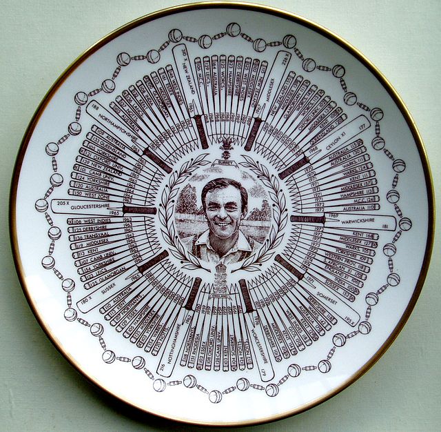 A Coalport china plate bearing a central portrait of John Edrich, encircled by bats and stumps, each containing details of one of his hundred first-class centuries. The design is completed by a border of balls and bails, and edged in gold.
