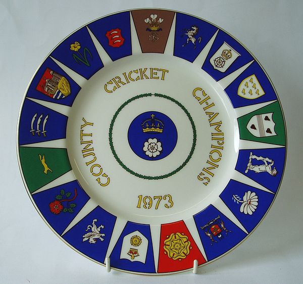 A Coalport china plate decorated with a central design of the Hampshire county badge, the outer rim incorporates badges of all seventeen first-class counties.