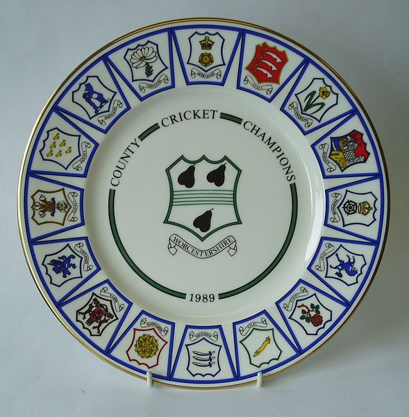 A Royal Grafton china plate decorated with a central design of the county badge. The outer rim incorporates a design of sixteen county badges.
