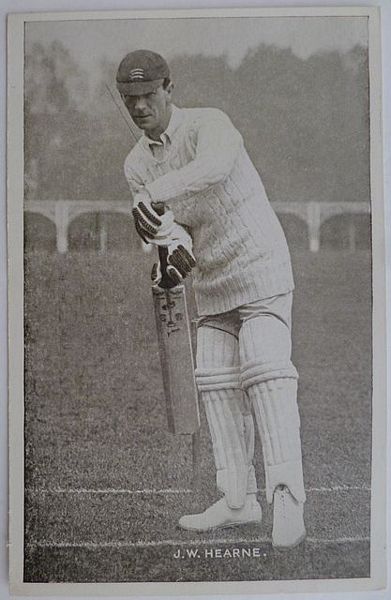 An original full length postcard photograph of J.W. Hearne batting.