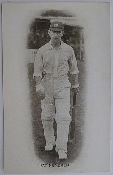 An original full-length postcard photograph of Patsy Hendren walking to the wicket.