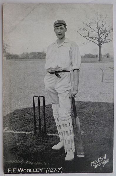 An original full-length postcard photograph of Frank Woolley standing at the wicket, holding a cricket bat.