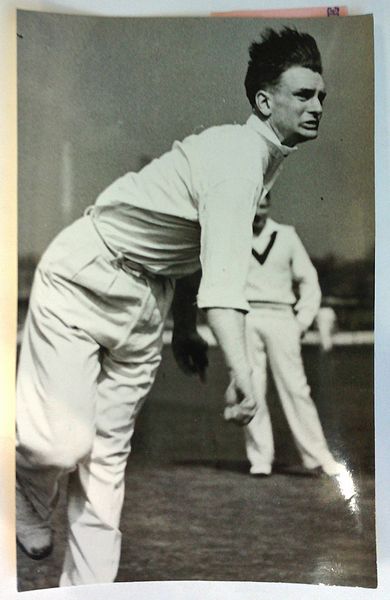 An original full-length postcard-size action photograph of Peter Greenwood bowling.