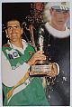 An original half-quarter length colour postcard photograph of Hansie Cronje holding a trophy.