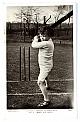 An original postcard photograph of a young boy standing at the wicket, bat raised.
