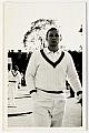 An original three-quarter length postcard-size photograph of Richie Benaud with hand in pocket.