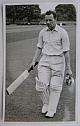 An original full-length postcard-size photograph of Alan Wharton walking off the field.
